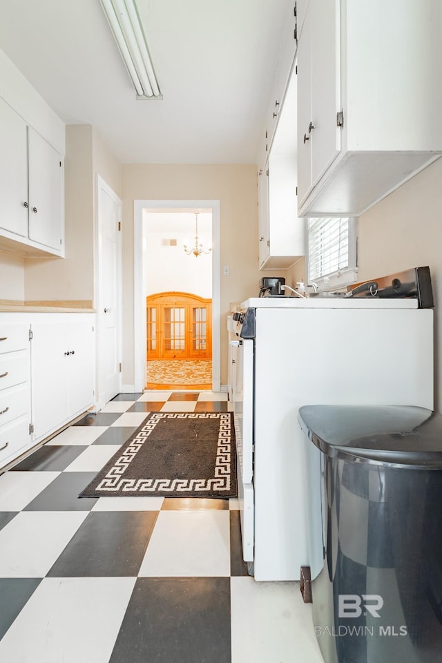 kitchen featuring white cabinetry and an inviting chandelier