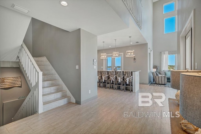 stairs featuring a chandelier and a healthy amount of sunlight