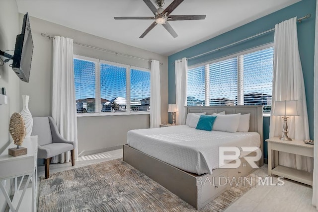 tiled bedroom featuring ceiling fan