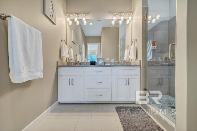 bathroom with tile patterned floors, vanity, and an enclosed shower