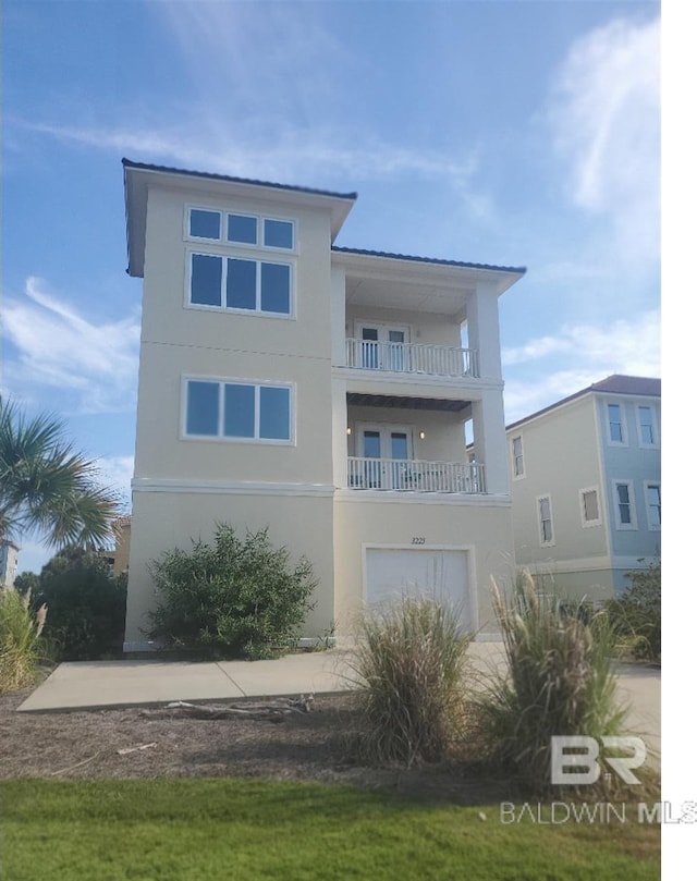 view of front of house featuring a balcony and a garage