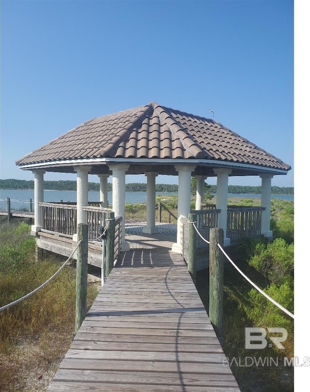 view of dock with a gazebo and a water view