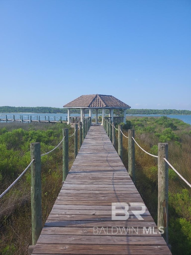 view of dock featuring a gazebo and a water view