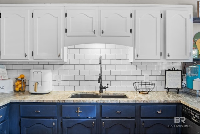 kitchen featuring blue cabinets, white cabinetry, tasteful backsplash, black dishwasher, and sink