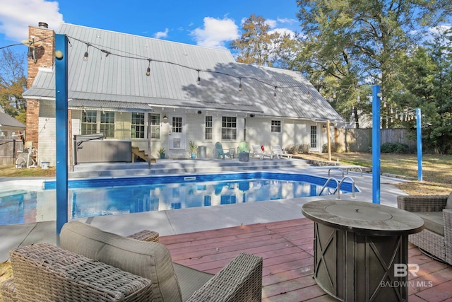 view of swimming pool featuring a wooden deck, a grill, an outdoor structure, and a hot tub