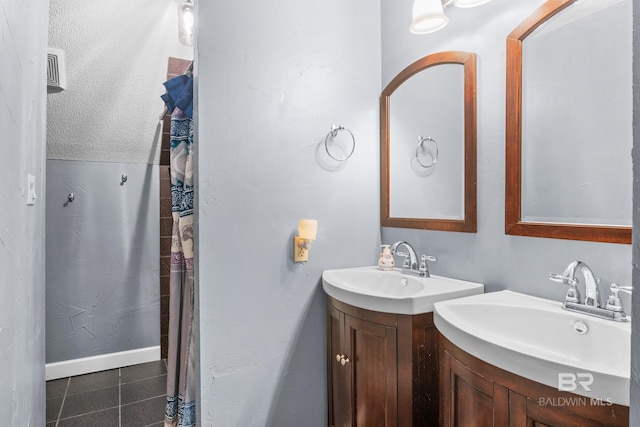 bathroom with tile patterned flooring and vanity