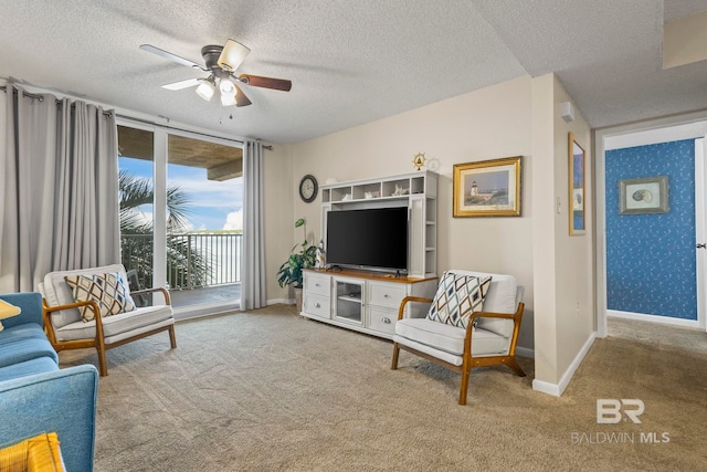 living room featuring light colored carpet, ceiling fan, and a textured ceiling