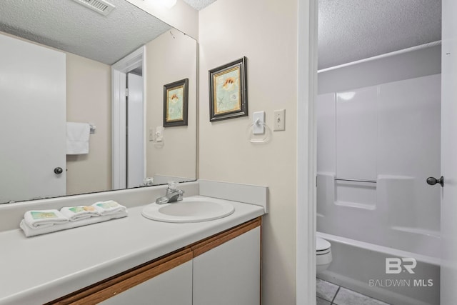 full bathroom with vanity, tile patterned flooring, a textured ceiling, shower with separate bathtub, and toilet