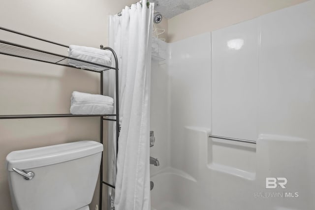 bathroom with shower / bath combo, a textured ceiling, and toilet