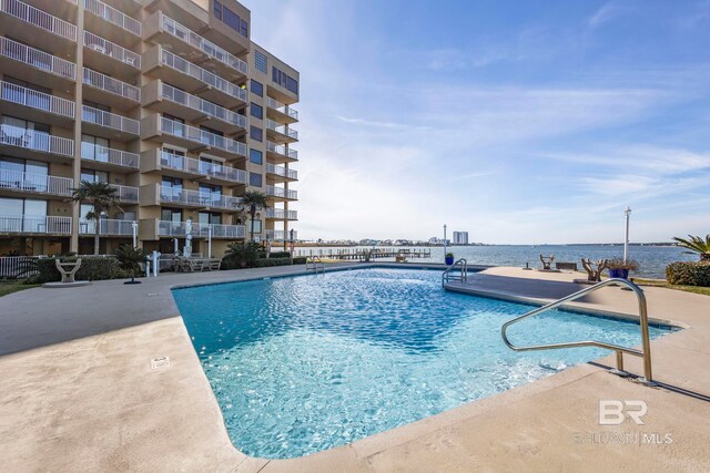 view of swimming pool with a water view