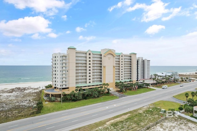 drone / aerial view featuring a view of the beach and a water view