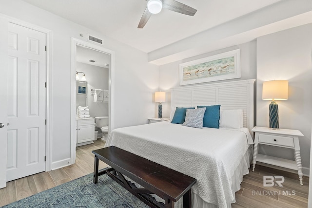 bedroom featuring ensuite bathroom, ceiling fan, and light hardwood / wood-style flooring