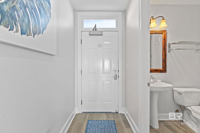 doorway to outside with hardwood / wood-style flooring and sink