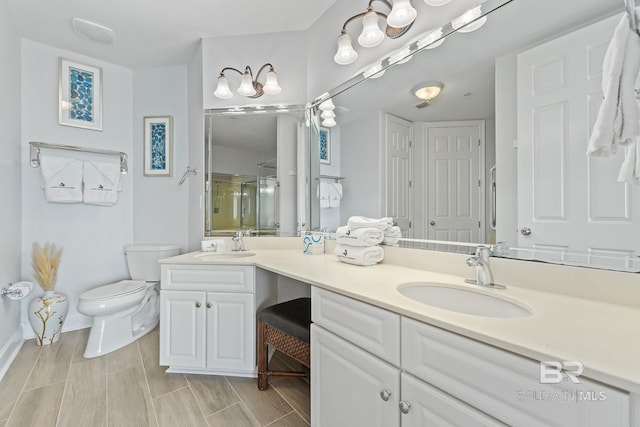 bathroom featuring vanity, hardwood / wood-style flooring, toilet, and a shower with door