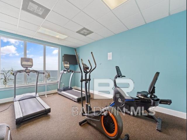 exercise room with a paneled ceiling