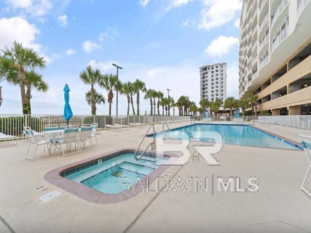 view of swimming pool with a patio area and a hot tub