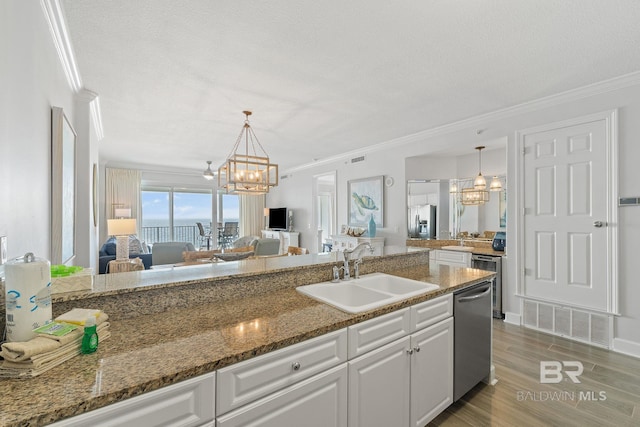 kitchen featuring sink, stainless steel appliances, dark stone countertops, white cabinets, and hardwood / wood-style flooring