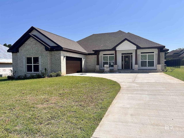 view of front of house featuring a front yard and a garage