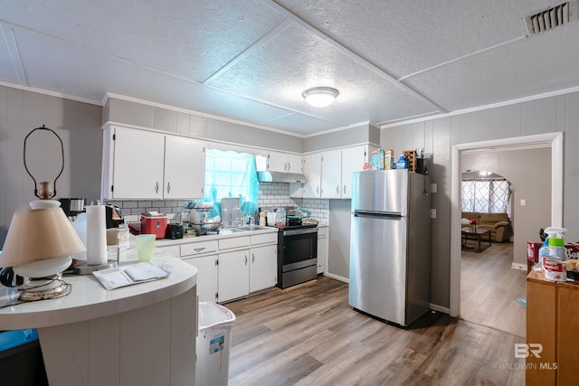 kitchen with light hardwood / wood-style floors, white cabinetry, and stainless steel appliances