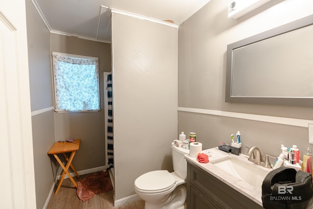 bathroom with hardwood / wood-style flooring, toilet, vanity, and ornamental molding