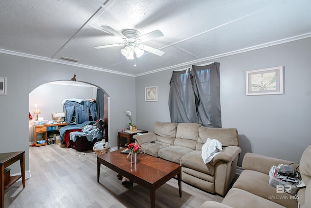 living room featuring ceiling fan, ornamental molding, and hardwood / wood-style flooring