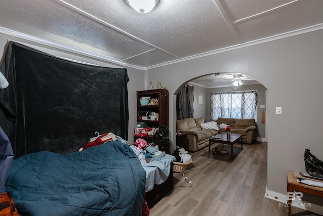 bedroom featuring hardwood / wood-style flooring and crown molding