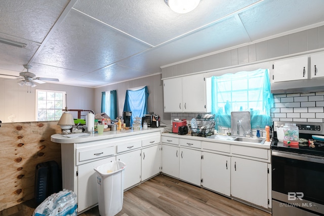 kitchen featuring tasteful backsplash, white cabinetry, and stainless steel electric range