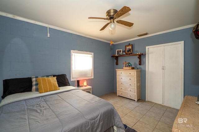 bedroom with light tile patterned floors, a closet, ceiling fan, and crown molding