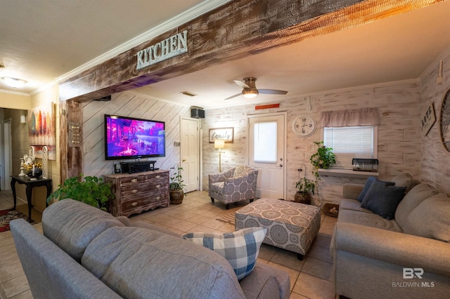 tiled living room featuring ceiling fan and crown molding