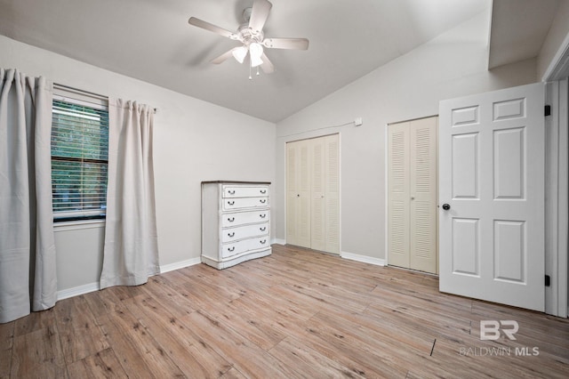 unfurnished bedroom featuring ceiling fan, light hardwood / wood-style floors, and vaulted ceiling