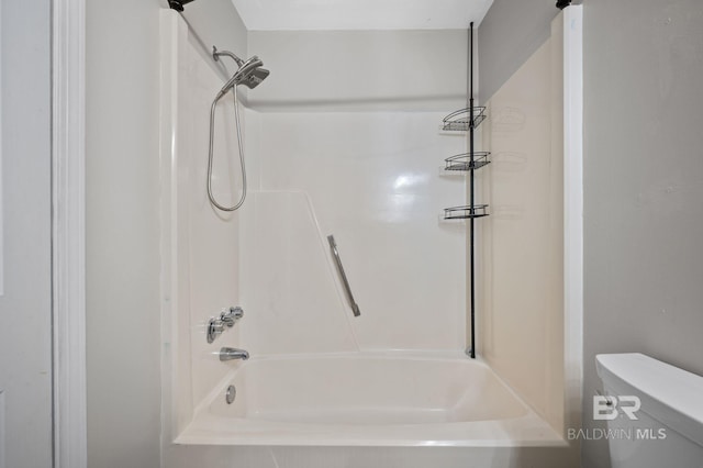 bathroom featuring bathing tub / shower combination and toilet