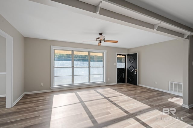 spare room with wood-type flooring and ceiling fan