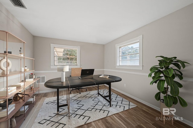 home office with hardwood / wood-style floors