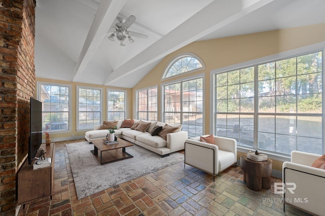 sunroom featuring vaulted ceiling with beams and ceiling fan