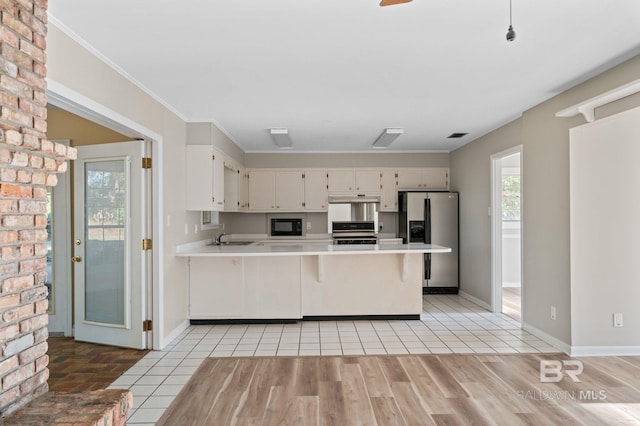 kitchen featuring kitchen peninsula, stainless steel fridge with ice dispenser, white cabinets, and range