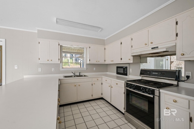 kitchen featuring ornamental molding, gas range oven, sink, white cabinets, and light tile patterned flooring