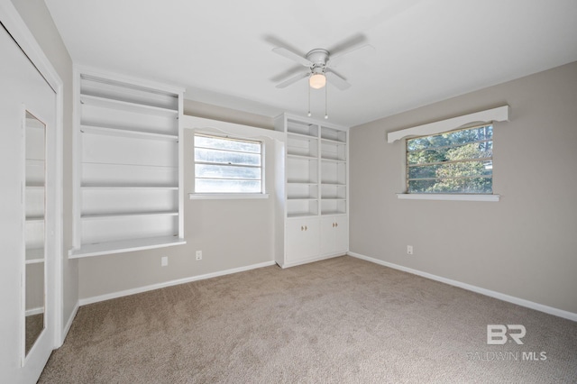 unfurnished bedroom featuring light colored carpet and ceiling fan