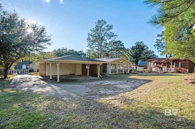 rear view of property with a carport