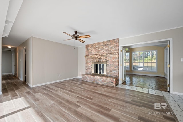 unfurnished living room with ceiling fan, a fireplace, and wood-type flooring