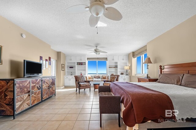 bedroom featuring ceiling fan, a textured ceiling, and light tile patterned flooring