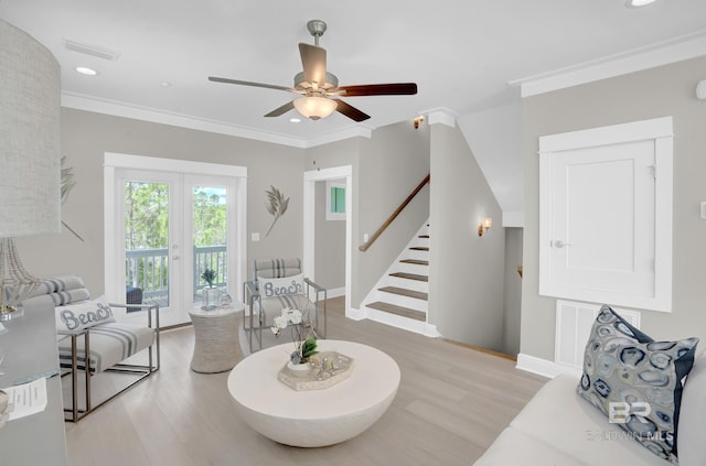 living room featuring light wood finished floors, recessed lighting, crown molding, and stairs