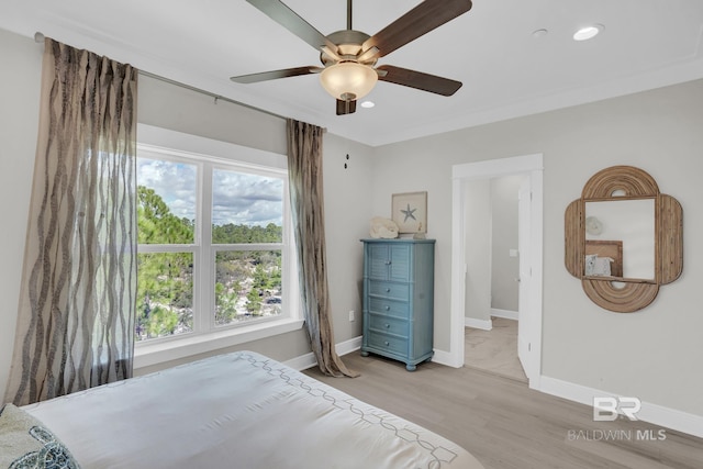 bedroom with light wood-type flooring, a ceiling fan, recessed lighting, crown molding, and baseboards