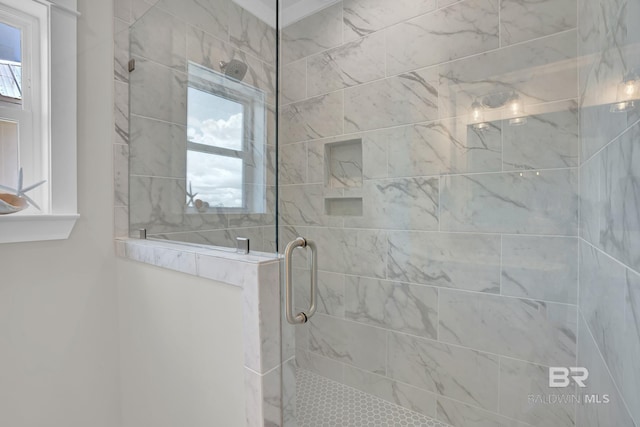 bathroom featuring plenty of natural light and tiled shower