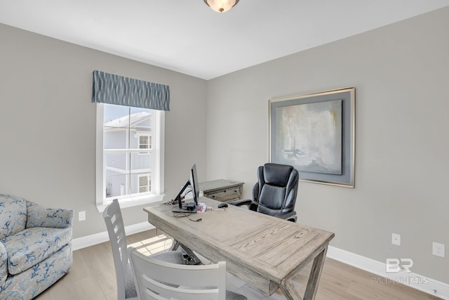 office with light wood-style floors and baseboards