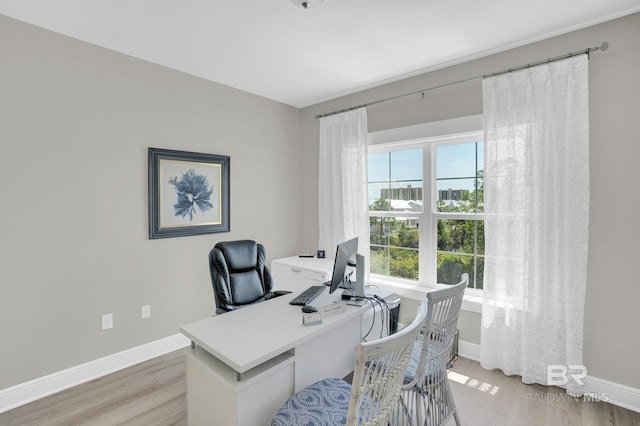 home office with light wood finished floors and baseboards