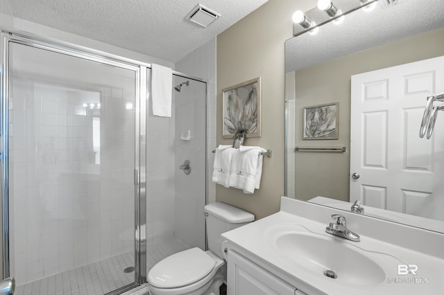 bathroom with a textured ceiling, toilet, a shower stall, and visible vents