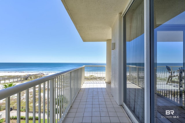 balcony with a water view and a beach view