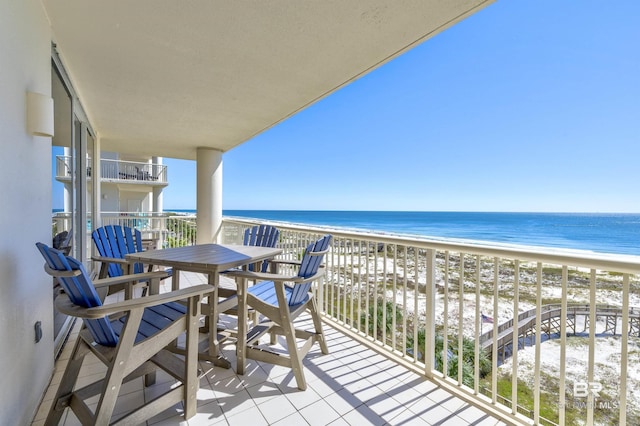 balcony with a view of the beach and a water view