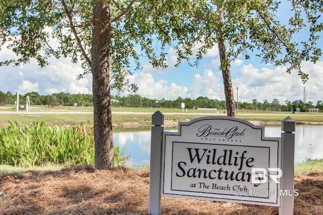 community / neighborhood sign with a water view