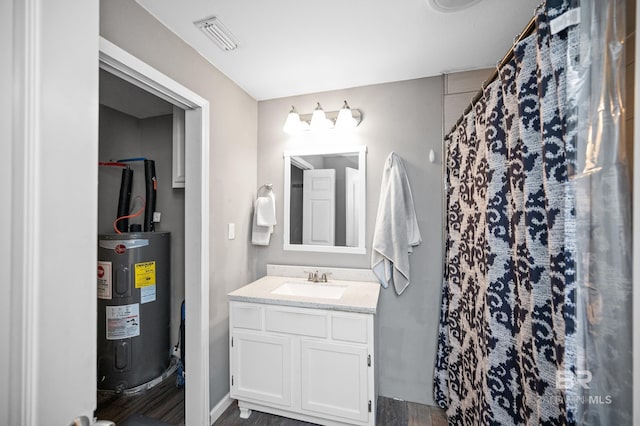 bathroom featuring hardwood / wood-style floors, vanity, electric water heater, and a shower with curtain